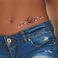 Lotus tattoo with rhinestones on hip